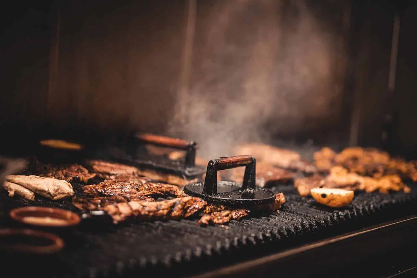 Meat on a grill with steam coming out of itDescription automatically generated